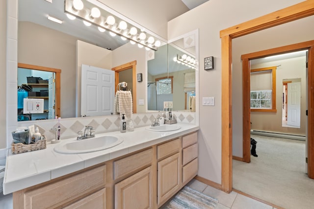 bathroom featuring baseboard heating, tile patterned floors, tasteful backsplash, and vanity