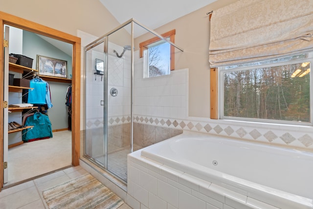 bathroom featuring tile patterned floors, vaulted ceiling, and independent shower and bath