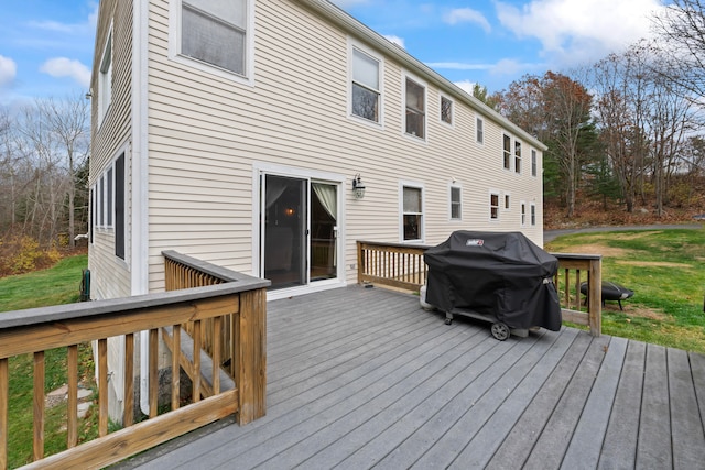 deck with area for grilling and a lawn