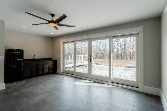 doorway to outside featuring french doors, tile patterned flooring, and ceiling fan