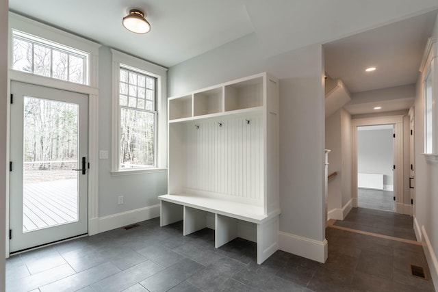 mudroom featuring dark tile patterned flooring