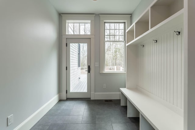 mudroom featuring dark tile patterned flooring