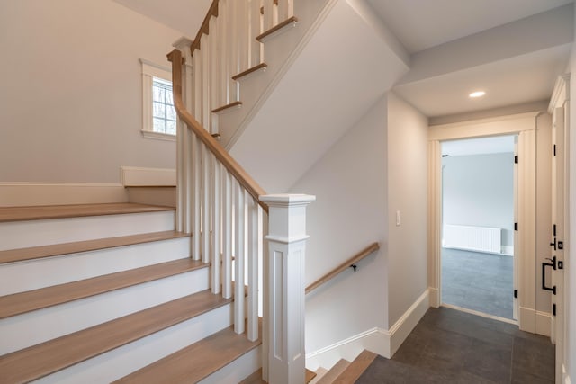 stairway featuring radiator heating unit and tile patterned floors