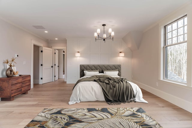 bedroom with a chandelier, light wood-type flooring, and ornamental molding