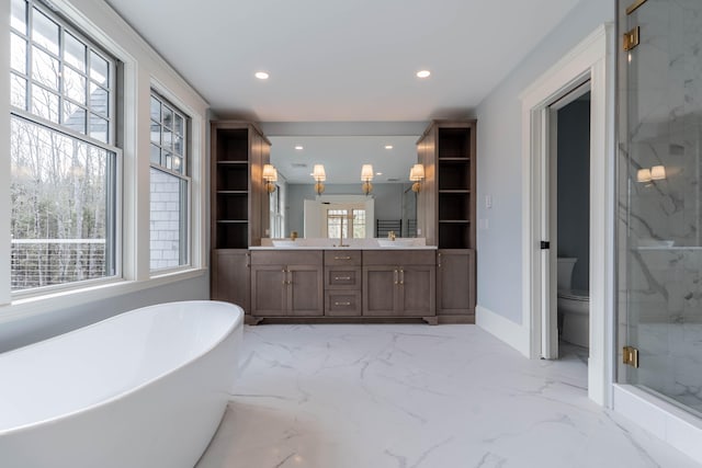 full bathroom featuring toilet, vanity, and separate shower and tub