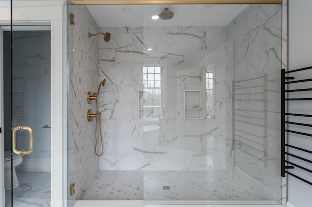 bathroom featuring walk in shower and toilet