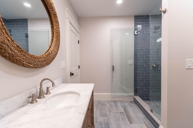 bathroom featuring vanity and a tile shower