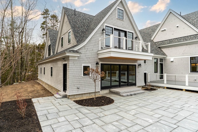 rear view of house featuring a patio area and a balcony