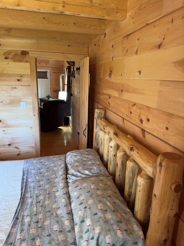 unfurnished bedroom with wood walls and wood-type flooring