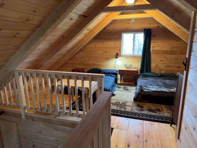 interior space featuring light hardwood / wood-style floors, wood ceiling, wooden walls, and lofted ceiling with beams