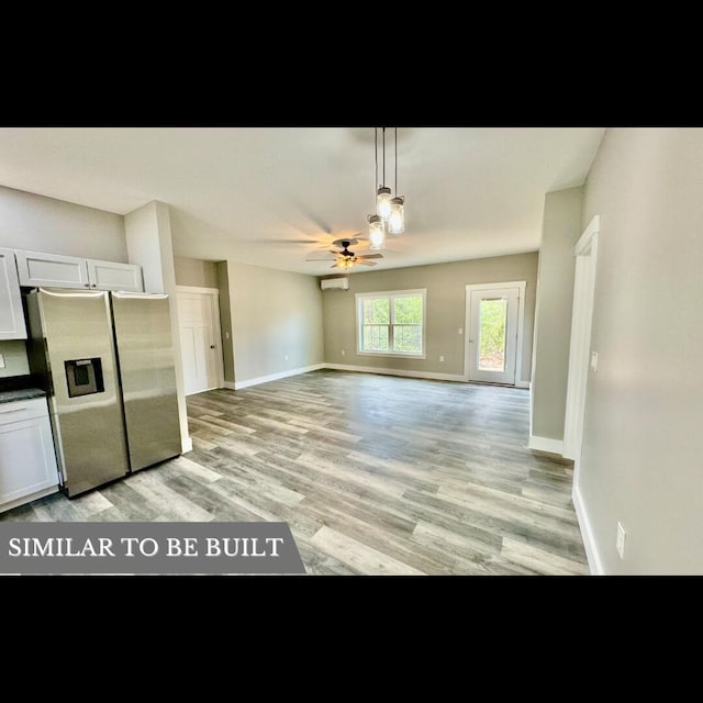 kitchen featuring ceiling fan, light hardwood / wood-style flooring, stainless steel refrigerator with ice dispenser, decorative light fixtures, and white cabinets