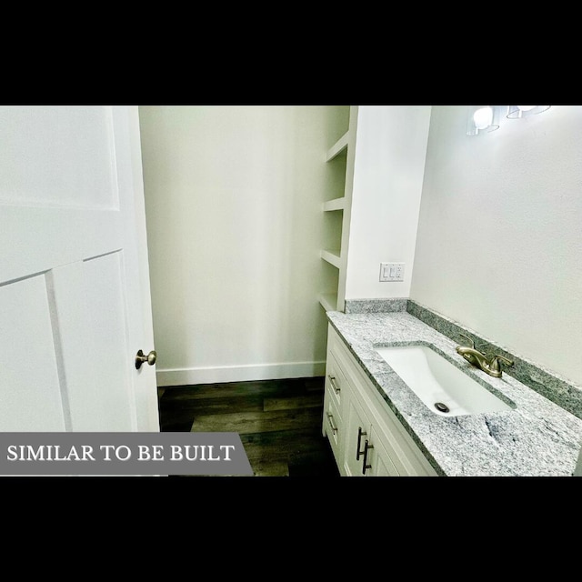 bathroom with hardwood / wood-style floors and vanity