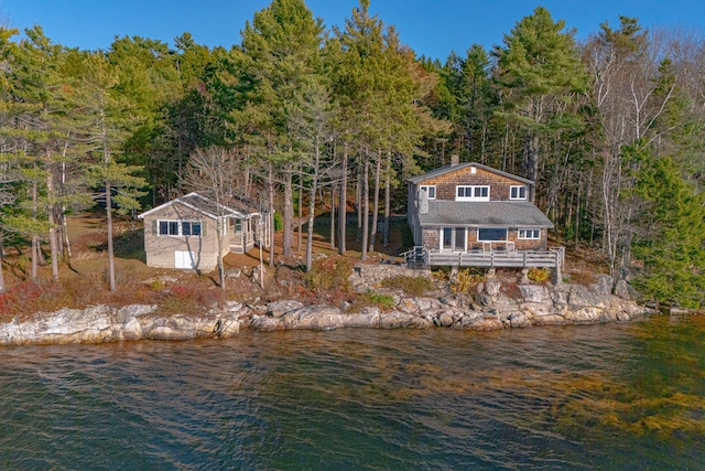 back of house featuring a deck with water view