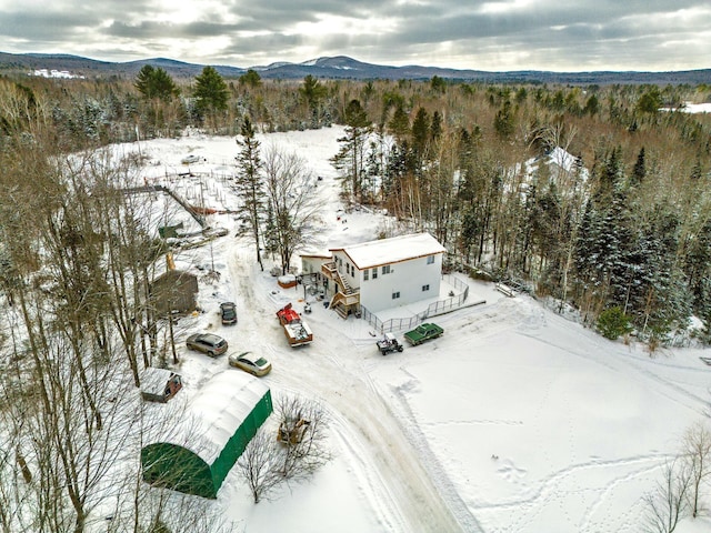 snowy aerial view with a mountain view