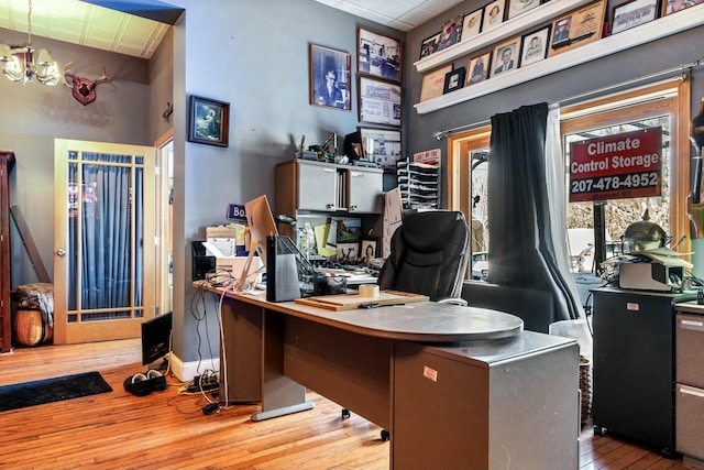 office featuring a chandelier and light hardwood / wood-style floors