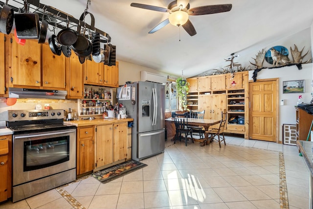 kitchen featuring vaulted ceiling, light tile patterned floors, ceiling fan, stainless steel appliances, and backsplash