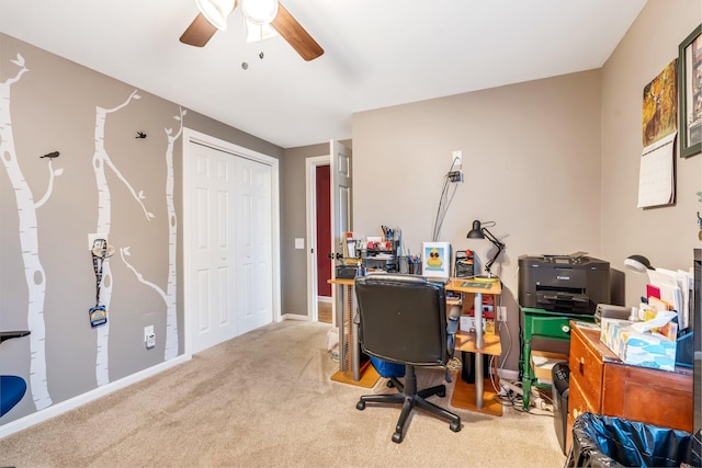 carpeted office featuring ceiling fan