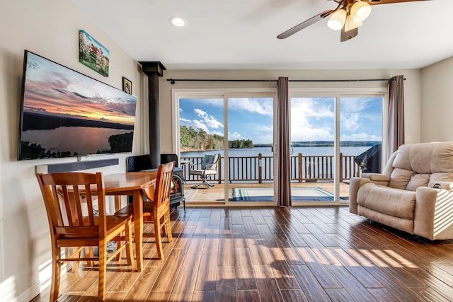 interior space featuring hardwood / wood-style floors, ceiling fan, and a water view