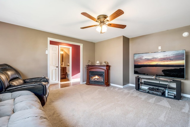 carpeted living room featuring ceiling fan