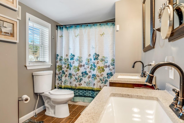 bathroom with vanity, hardwood / wood-style flooring, and toilet