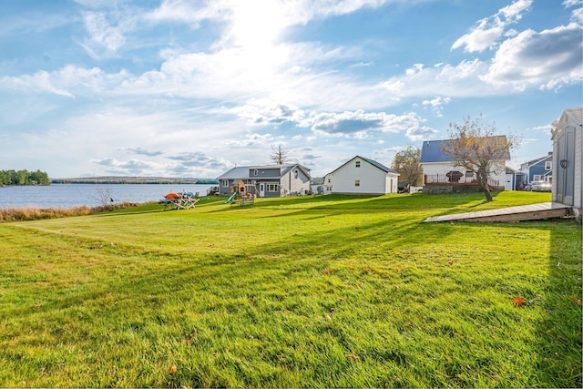 view of yard with a playground and a water view