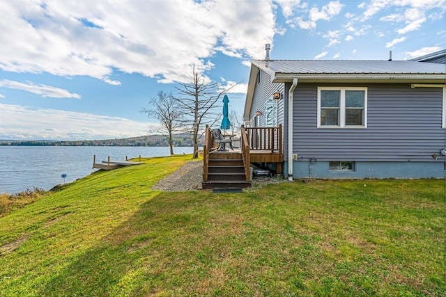 view of yard featuring a deck with water view