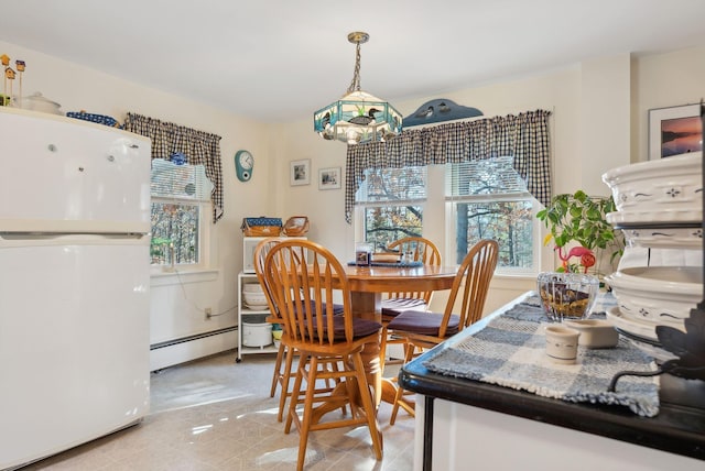 dining space featuring baseboard heating and light tile patterned flooring