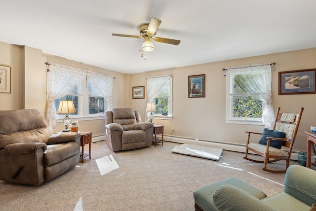 living room featuring light carpet, a wealth of natural light, and a baseboard heating unit