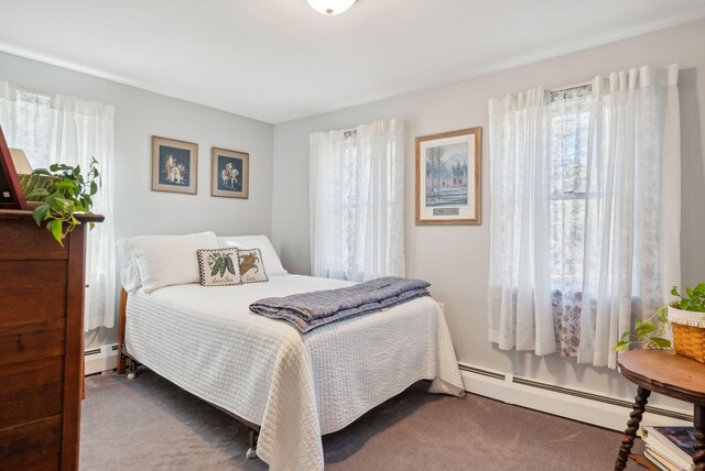 carpeted bedroom featuring baseboard heating