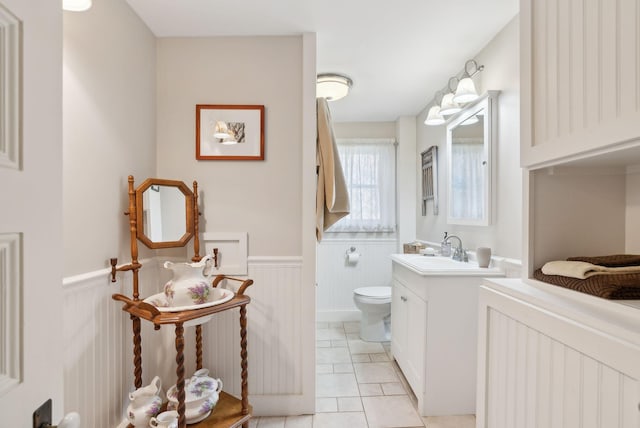 bathroom featuring tile patterned flooring, vanity, and toilet