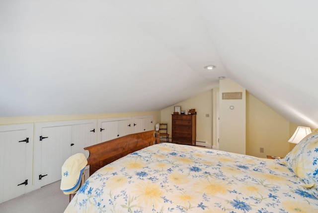 carpeted bedroom featuring a baseboard radiator and vaulted ceiling