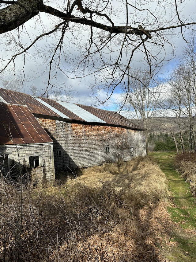 view of side of home with roof mounted solar panels