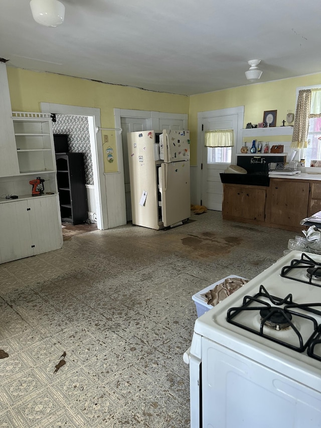 kitchen featuring open shelves and white appliances