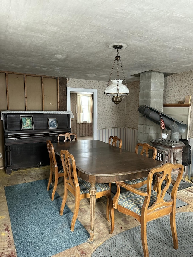 dining space featuring wallpapered walls