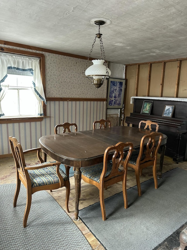 dining room featuring wallpapered walls