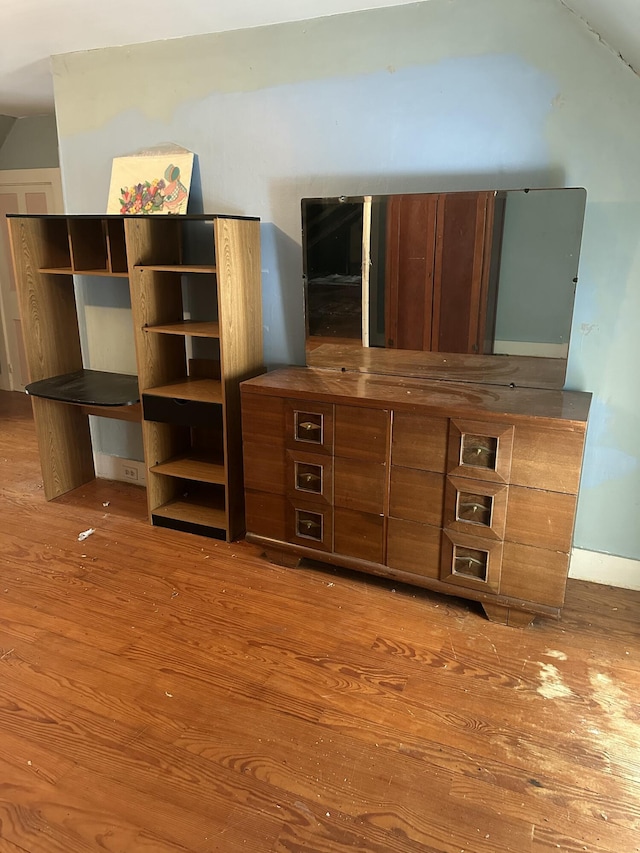 unfurnished living room featuring vaulted ceiling and wood finished floors