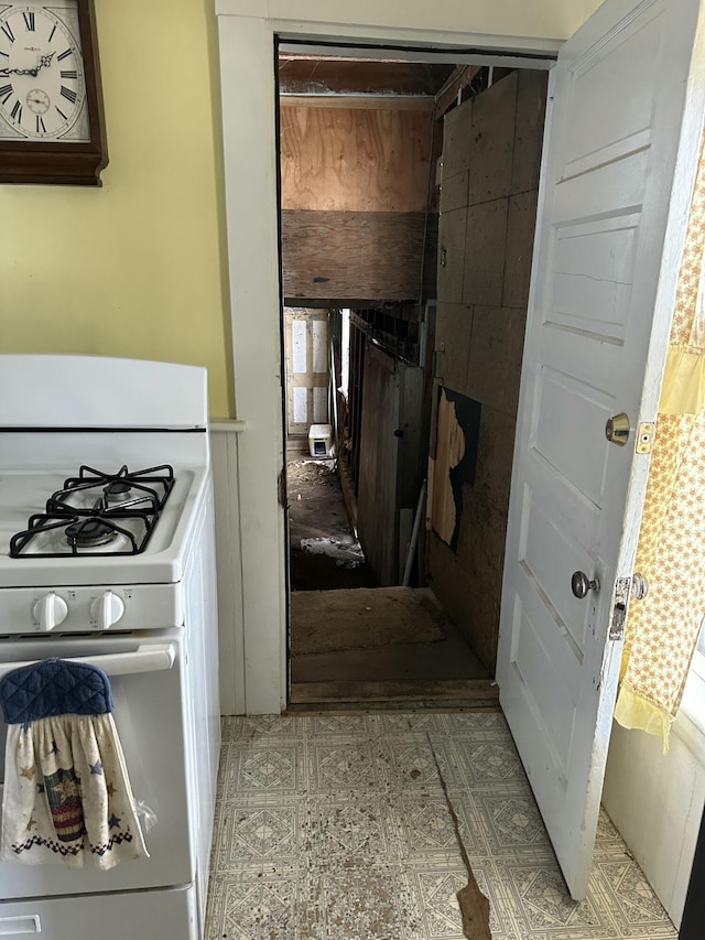 interior space featuring white range with gas stovetop and light floors