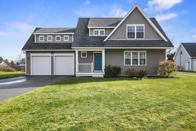 view of front of property featuring a front yard and a garage