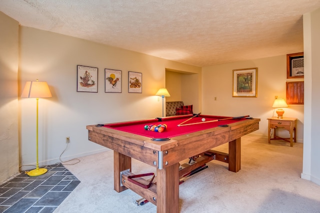 playroom with light colored carpet, a textured ceiling, and billiards