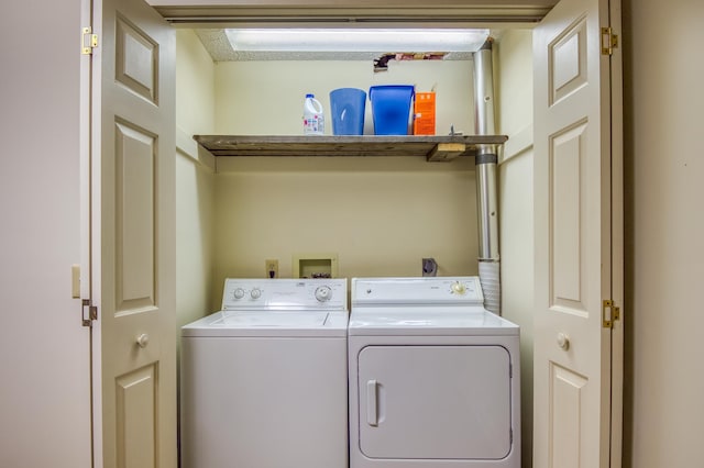 clothes washing area featuring washer and dryer