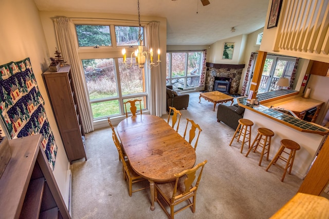 dining room featuring a wood stove, ceiling fan with notable chandelier, lofted ceiling, and a textured ceiling