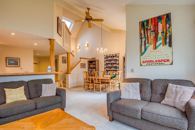 carpeted living room featuring high vaulted ceiling and ceiling fan with notable chandelier