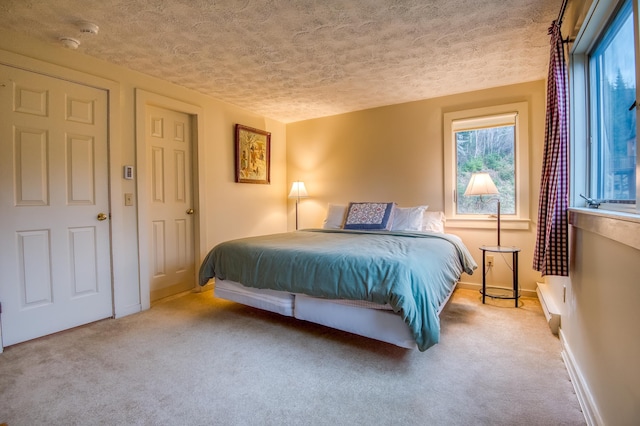 carpeted bedroom with a textured ceiling