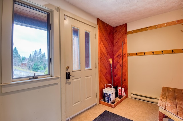 carpeted entryway featuring a textured ceiling and a baseboard radiator