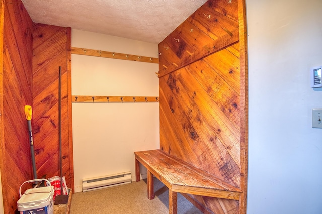 mudroom featuring a baseboard heating unit, carpet floors, and a textured ceiling