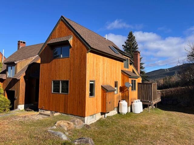 view of side of home featuring a yard