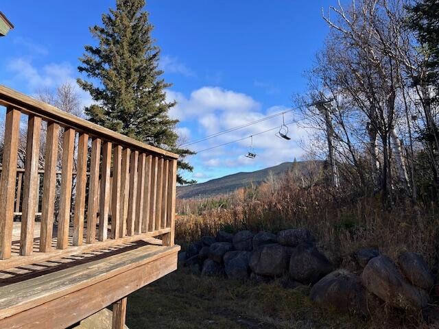 view of yard with a deck with mountain view