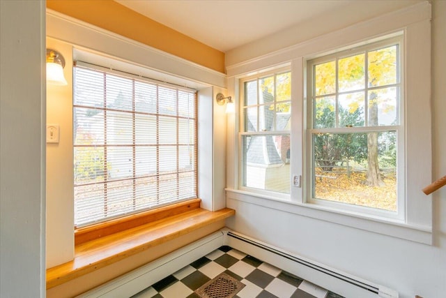 unfurnished sunroom featuring baseboard heating