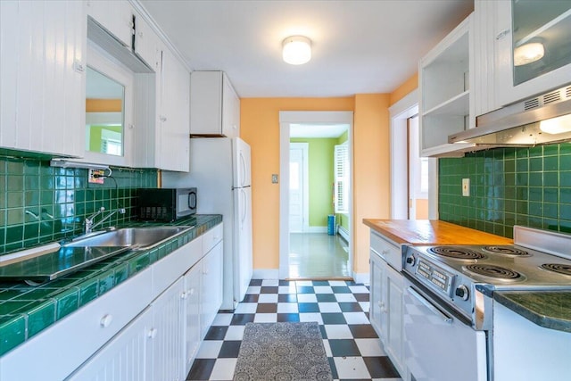 kitchen featuring electric stove, white cabinetry, and decorative backsplash