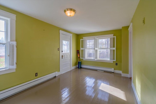 entryway featuring light wood-type flooring and a baseboard heating unit